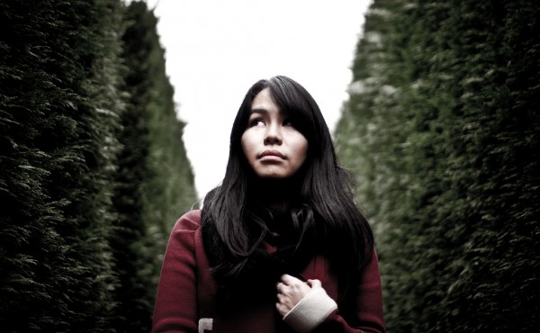 Lady afraid while walking in a garden