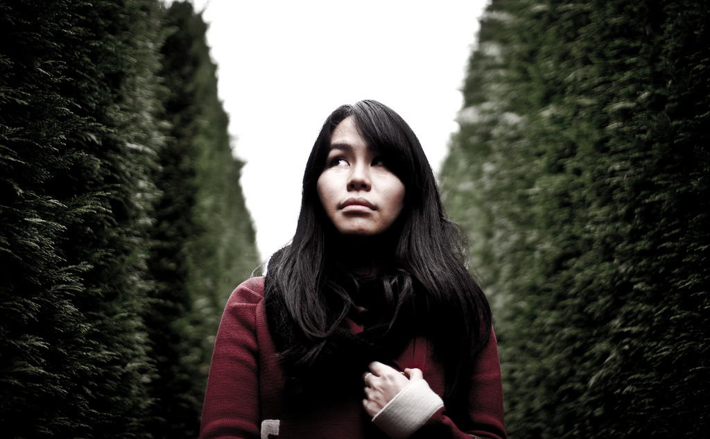 Lady afraid while walking in a garden